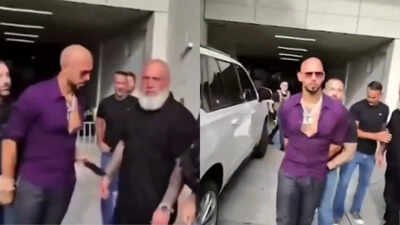 Watch: Andrew Tate appears to pass phone to team member as US Marshals arrest him over UK charges