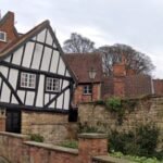 In 1933, Lincoln’s Crooked House was marked for demolition; work revealed a hidden timber-framed building behind its brick façade and saved it; today it is one of the Cathedral Quarter’s most photographed buildings