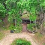 A Missouri engineer bought remote Ozarks land in 1970 and slowly built a reinforced-concrete home into the hillside; more than 50 years later, his son is restoring it room by room