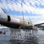 Canada lowered a retired Boeing 737 onto the seabed off Vancouver Island; the 100-foot jet now sits nearly 90 feet underwater as an artificial reef for marine life