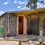 In 1964, an Arizona couple began building a carport with discarded bottles; years later, the project had grown into a 2,700-sq-ft home made with thousands of bottles and listed for 2,500