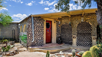 In 1964, an Arizona couple began building a carport with discarded bottles; years later, the project had grown into a 2,700-sq-ft home made with thousands of bottles and listed for 2,500