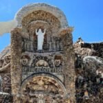 An Iowa priest vowed to build a shrine if he survived pneumonia; after recovering, he spent 42 years using over 100 train carloads of stone to create it
