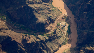 Three women were caught in a deadly Grand Canyon flash flood and clung to a rock ledge for 5 hours; after briefly believing each other had been swept away, a helicopter found them alive