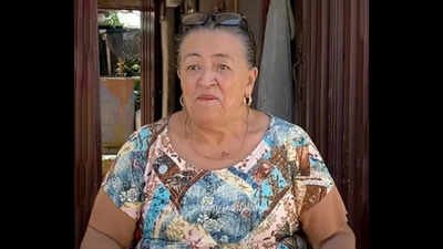 67-year-old Colombian woman makes money selling neighbourhood gossip; she carries a notebook, collects evidence, also takes payment to keep her mouth shut