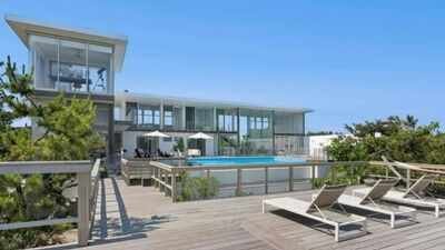 A Fire Island glass house drew 350+ viewers at .25 million but no buyer; after .255 million in cuts, its .995 million ask is still nearly .3 million above Cherry Grove’s record sale