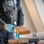 Vancouver workers opened a shipping container of T-shirts and found 14 duffle bags holding 329kg of cocaine worth C.8 million; police say it is the city’s largest-ever cocaine seizure