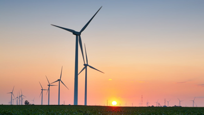 An Oregon wheat-farming couple had 13 wind turbines placed on their land; while crops continued around them, they said the operating turbines were bringing in about $100,000 a year