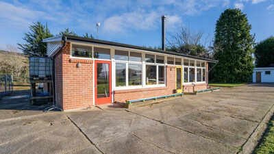 ​A New Zealand couple bought an abandoned school, then spent three years and about NZ0,000 turning the classroom into a home and chalet; the property is now listed for enquiries over NZ5,000