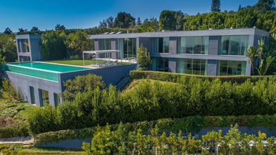 A developer bought a 0.59-acre Bel Air lot for .25 million in 2017 and spent nine years building a 10,950 sq ft brutalist mansion from 4,500 tons of reinforced concrete; it is now listed for .5 million