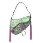A woman paid about £80 for a Dior bag in a Cotswolds charity shop without knowing if it was genuine; experts identified it as a rare 2003 Koi Saddle Bag, and it later sold for £7,870 | World News