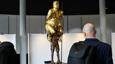 ‘The Orange Plague’: Why a golden, naked Trump is sitting on another man