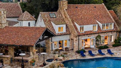 James Cagney’s former Beverly Hills estate was restored over many years, preserving its original fireplaces and leaded glass; the five-acre compound listed for $38.5 million is now asking $29.995 million