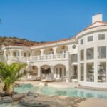 In 1991, John Stamos bought six acres in California for 0,000 and built a mansion; after later owners spent over  million renovating it, its asking price fell from  million to .4 million by 2026