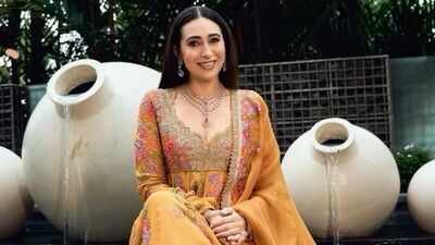 Karisma Kapoor showcases timeless ethnic elegance in a yellow Anarkali set worth Rs 2.95 lakh with intricate zardozi embroidery |