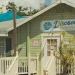 Florida couple’s colorful Sarasota cottage village houses 17 small businesses; a 324-apartment plan threatened demolition, but owners canceled the sale and took the property off market