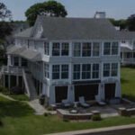 A glass-wrapped Connecticut waterfront home with views of Long Island Sound went to auction with bidding starting at .1 million; the lighthouse-inspired house sits directly on the shoreline