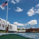 In 1961, Elvis Presley raised ,000 toward the USS Arizona Memorial; a year later, the 184-foot structure opened above the Pearl Harbor wreck, where more than 900 crewmen remain entombed and oil still leaks