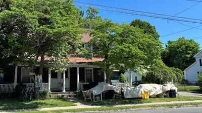 A Connecticut town paid $455,000 for a historic two-family home to create about 20 library parking spaces; a state preservation council has now voted to ask the attorney general to stop its demolition