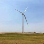 On a 160-acre Nebraska farm parcel, one wind turbine and its equipment use about 1 acre; the developer says a typical 30-year lease averages ,000 to ,500 a year, versus about 0 for top-dollar corn on that acre