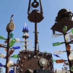 California cement worker Elmer Long turned discarded bottles and scrap metal into a desert art forest; as Route 66 turns 100, his two-acre ranch has 200 trees, 1,000+ bottles and visitors from around the world